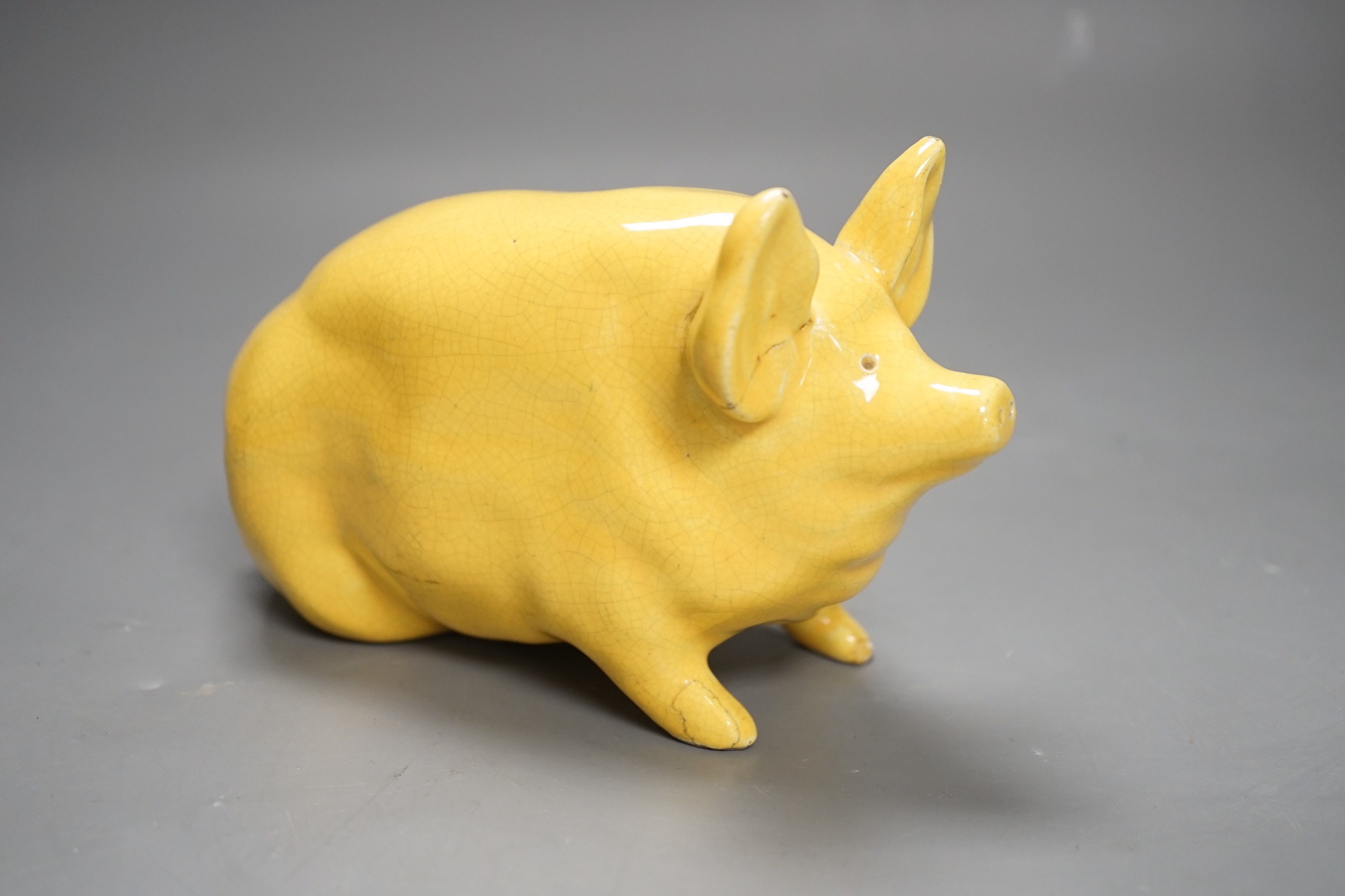 A Wemyss ware yellow glazed pig, 17cms long